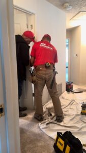 Two handymen from Ace Handyman ABQ SF installing a door frame in a home in Albuquerque, NM