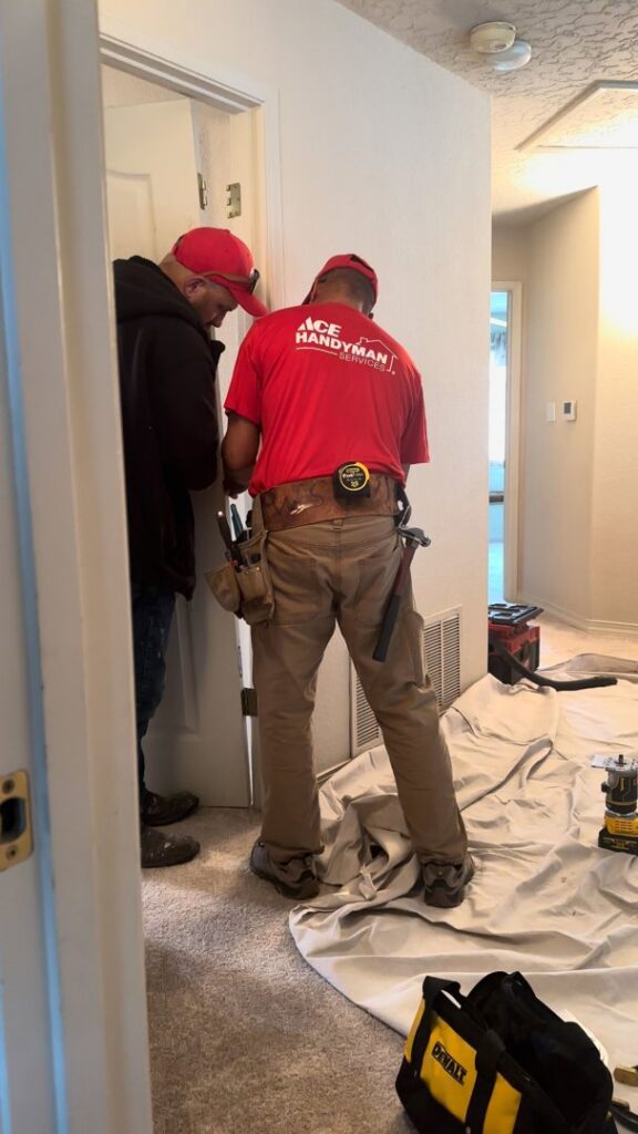 Two handymen from Ace Handyman ABQ SF installing a door frame in a home in Albuquerque, NM