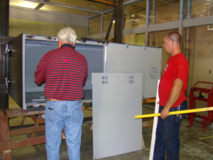 Two handymen installing a metal shelter unit for Smart Shelters of Kentucky in Hopkinsville, KY