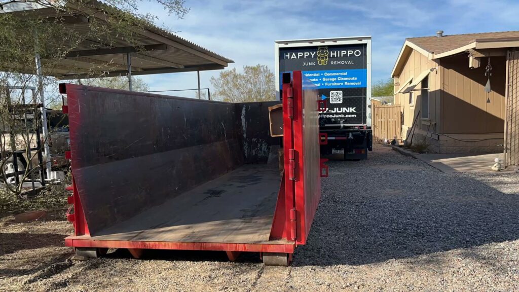 A Happy Hippo Junk Removal truck with a large dumpster for a job in Scottsdale, AZ.