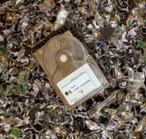 A hard drive resting on a pile of shredded electronic waste at SES Secure E-Waste Solutions Inc. in San Diego, CA.
