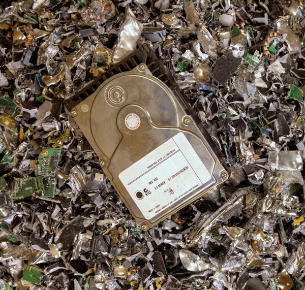A hard drive resting on a pile of shredded electronic waste at SES Secure E-Waste Solutions Inc. in San Diego, CA.