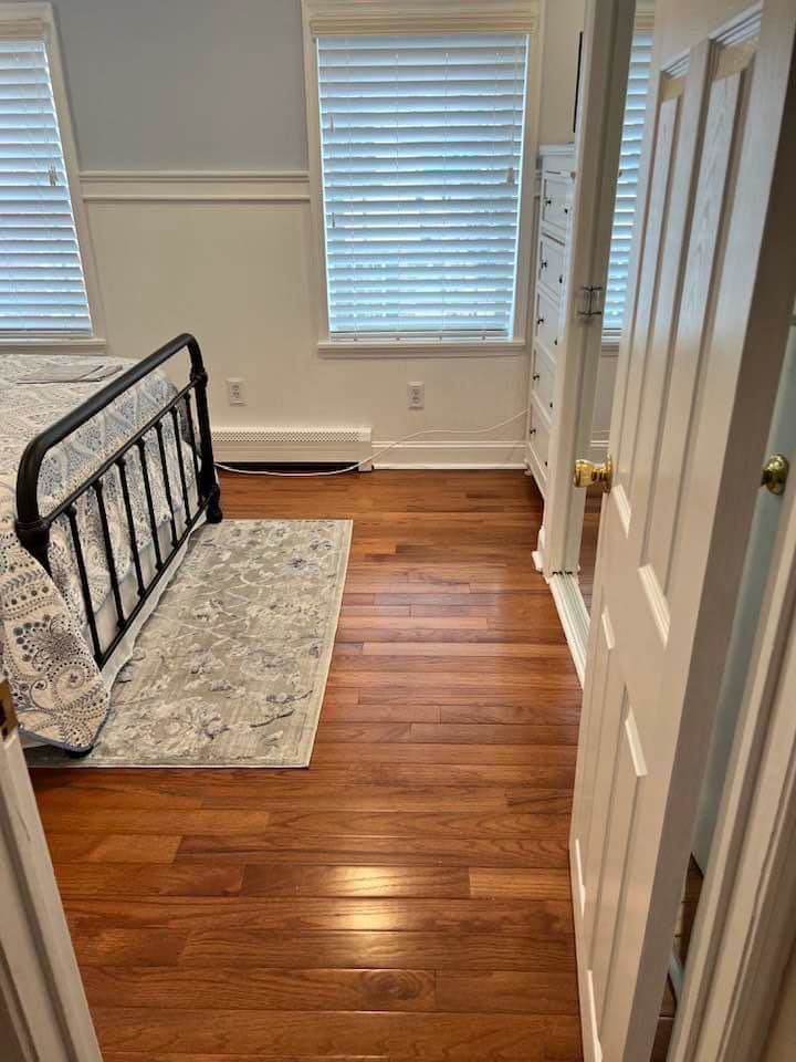 Hardwood floor installation in a bedroom by DunnWright Contractor in Pensacola, FL.