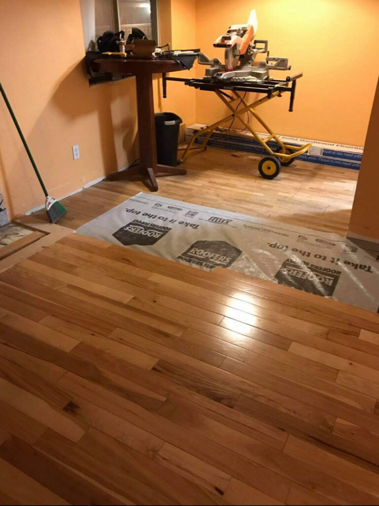 Hardwood floor installation in progress, with a miter saw and tools, performed by MDJ Handyman in Salt Lake City, UT.