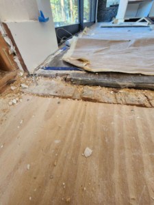 Hardwood floor installation preparation showing subfloor and debris at a job site by Burleson De Lago Real Hardwood Floors in Austin, TX.