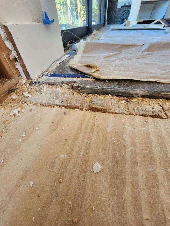 Hardwood floor installation preparation showing subfloor and debris at a job site by Burleson De Lago Real Hardwood Floors in Austin, TX.