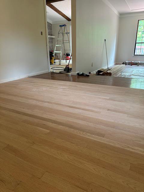 Hardwood floor installation or refinishing in progress, with tools visible, by Enjaycee Unlimited in Cincinnati, OH.