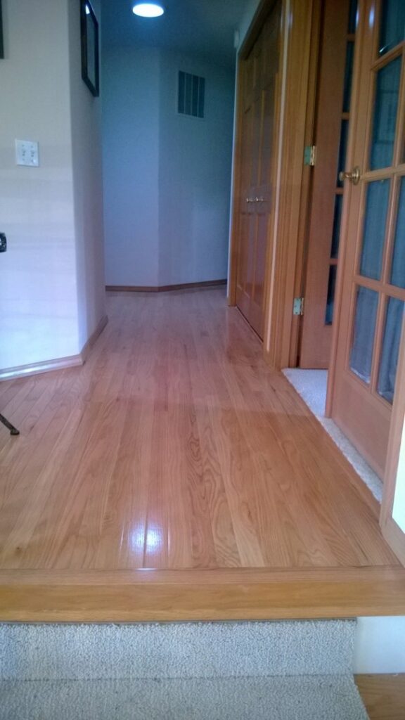 New hardwood floor installation in a hallway, a home improvement service by TPF Services in Yakima, WA.