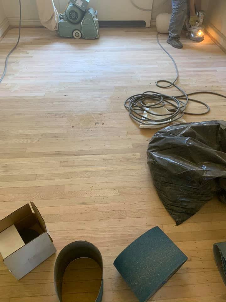 Hardwood floor refinishing equipment on an unfinished floor by Just Floor It Hardwood Floors LLC in Philadelphia, PA