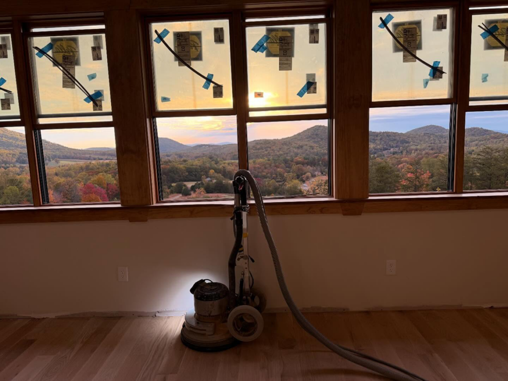 A floor sanding machine in use on a hardwood floor by Heritage Floors of Hanover LLC in Mechanicsville, VA.