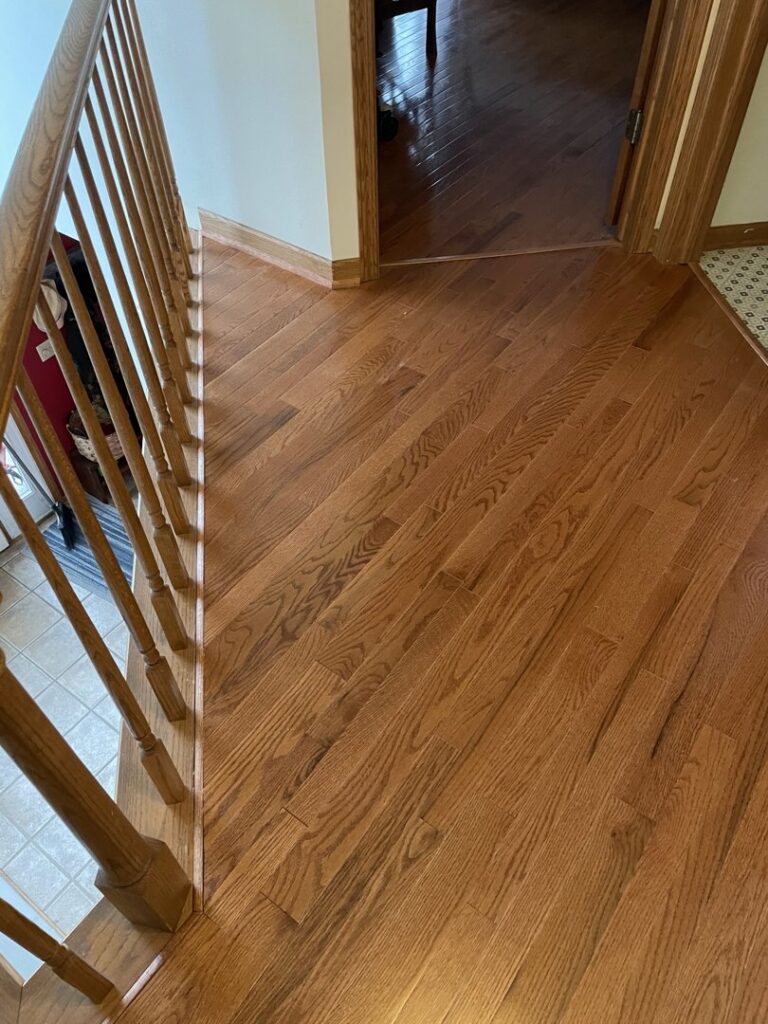 New hardwood flooring and stair refinishing project by Top Notch Contracting in Racine, WI.