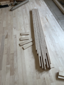 Bundles of hardwood flooring planks laid out on a floor, ready for installation by Birdseye Hardwoods LLC in Portland, OR