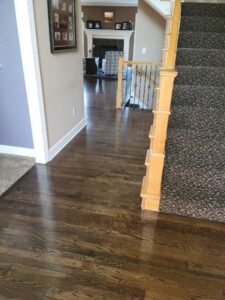 Newly installed hardwood flooring and carpeted stairs by Affordable Granite of KC in Kansas City, MO.