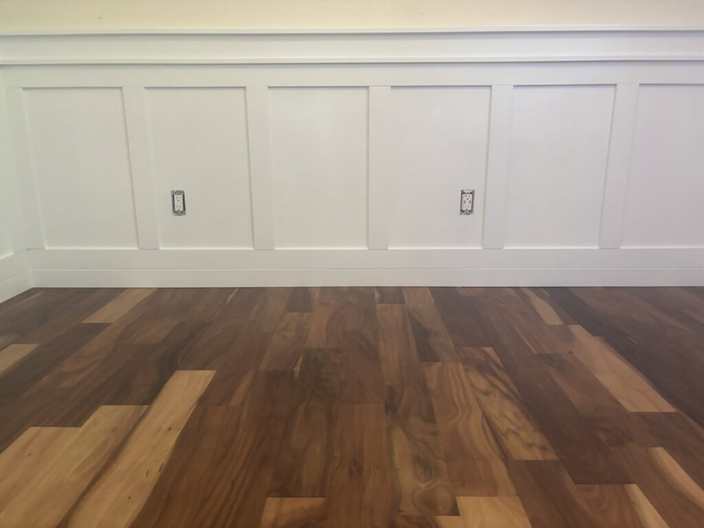 New hardwood flooring and wainscoting installed by Denver House Repair in Lakewood, CO.