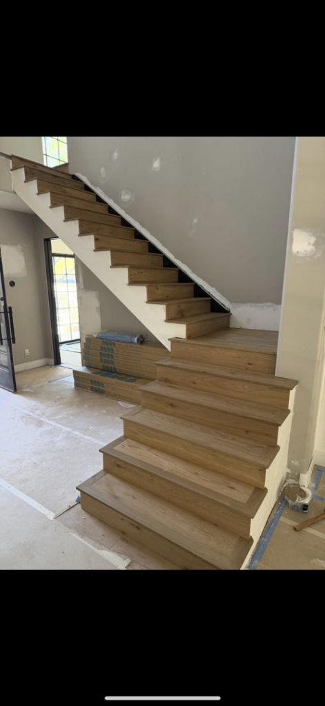 Hardwood staircase and flooring materials ready for installation by Arizona Prestige Flooring in Surprise, AZ