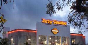 A completed Harley-Davidson dealership building with illuminated signs, a project by Walker Design & Construction Co. in Boca Raton, FL.