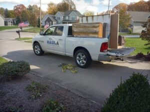 A HAULA Junk Removal truck loaded with furniture and boxes, ready for transport in Canton, OH.