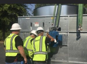 Hays Service technicians installing a component on an industrial HVAC unit in Macon, GA