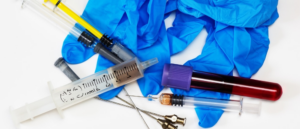 Hazardous medical waste, including syringes and blood tubes, for safe disposal by Secure Waste Corp in Orlando, FL.