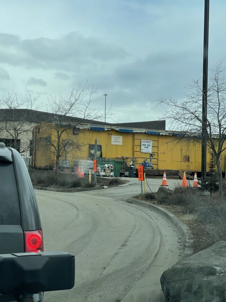 A hazardous material collection point with a yellow building at Municipality of Anchorage Solid Waste Services in Anchorage, AK.