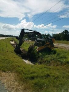 Heavy equipment, including an excavator and skid steer, performing environmental excavation for Environmental & Hazmat Services in Ashford, AL.