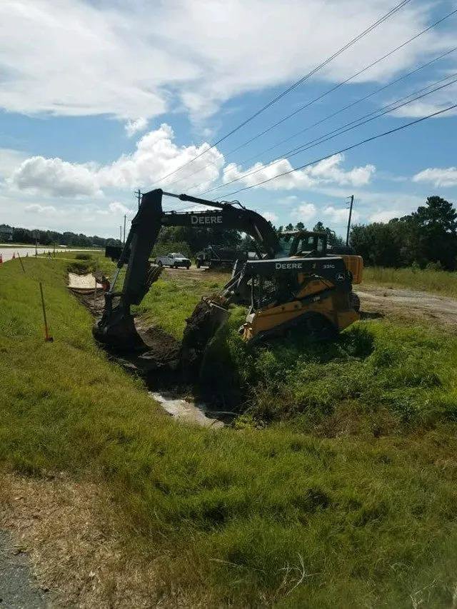 Heavy equipment, including an excavator and skid steer, performing environmental excavation for Environmental & Hazmat Services in Ashford, AL.