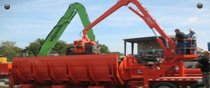 Heavy equipment loading scrap metal into a large container for Metal Recycling Inc in Johnson City, TN