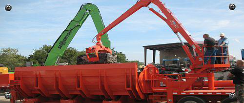 Heavy equipment loading scrap metal into a large container for Metal Recycling Inc in Johnson City, TN