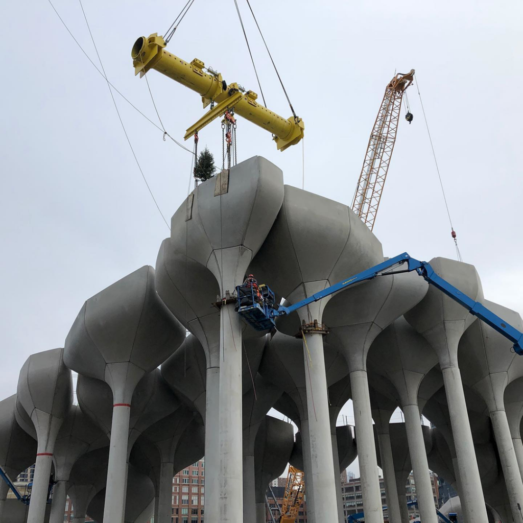 A heavy lift crane placing equipment on a concrete structure during construction by Weeks Marine, Inc. in Cranford, NJ