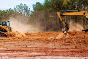Heavy machinery performing land clearing and site preparation for Carolina Property Solution and Tree Service in Concord, NC.