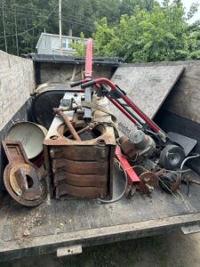 A trailer filled with heavy metal junk and old machinery for removal by CleanSite Solutions in Windham, ME.