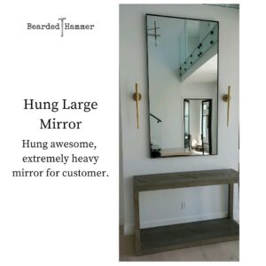 A large, heavy mirror expertly hung on a wall by Bearded Hammer LLC in Meridian, ID.