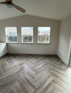 Herringbone pattern flooring and ceiling fan installed by Reborn Construction LLC in Wilsonville, OR.