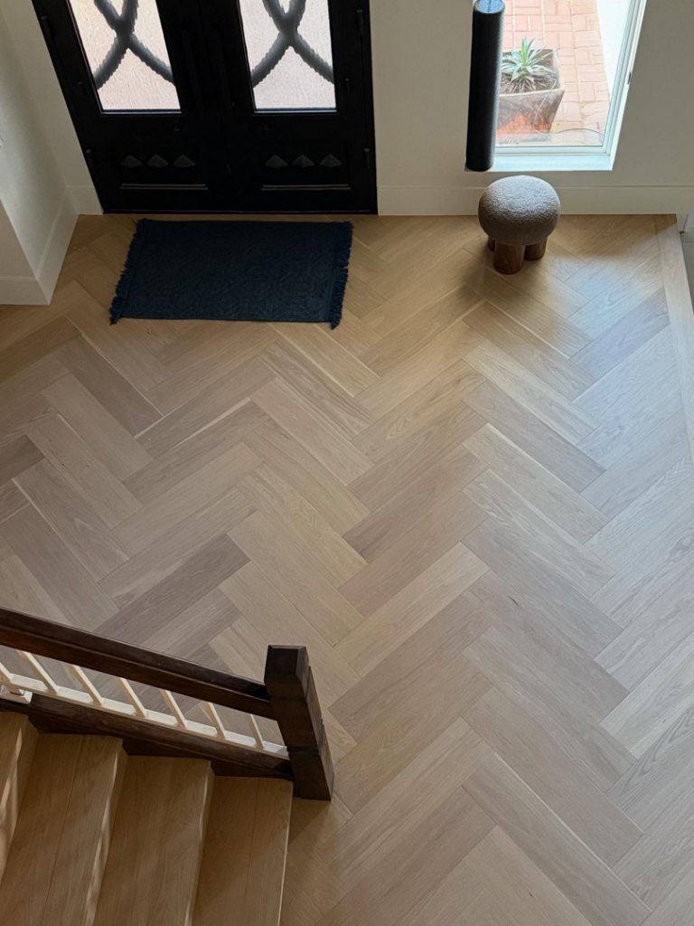 Stunning herringbone pattern hardwood floor in a home entryway installed by Arizona Prestige Flooring in Surprise, AZ