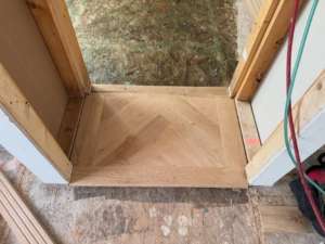 Hardwood floor installation in progress, showing a herringbone pattern by Heritage Floors of Hanover LLC in Mechanicsville, VA.