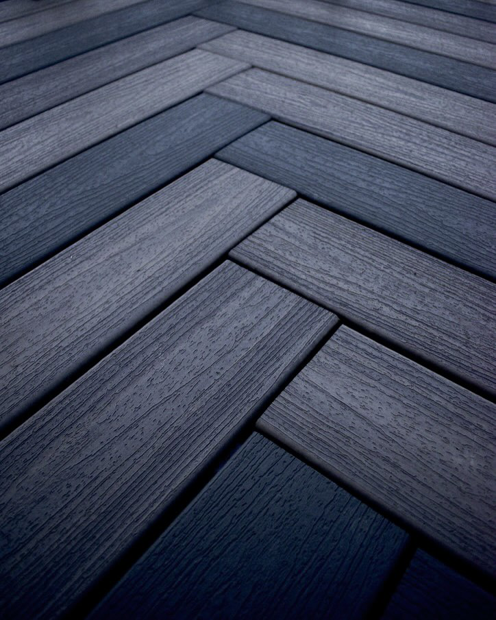 Close-up view of herringbone pattern deck flooring installed by TNC Builders, LLC in Aurora, CO