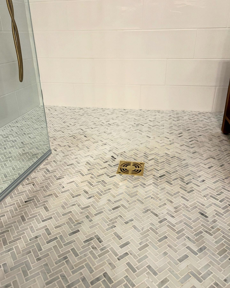 Herringbone tile shower floor installation by Wilson-Covington Construction in Winston Salem, NC