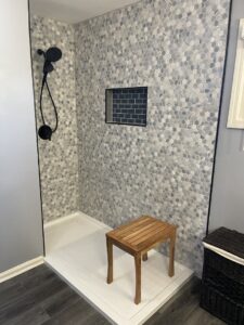 A newly installed shower with modern hexagonal tile walls by Luis handyman service in Albuquerque, NM