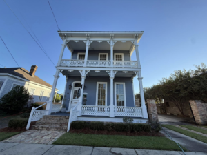 A beautiful historic house with blue siding and white railings, a perfect candidate for exterior cleaning by Ducky's Pro Wash in Mobile, AL.