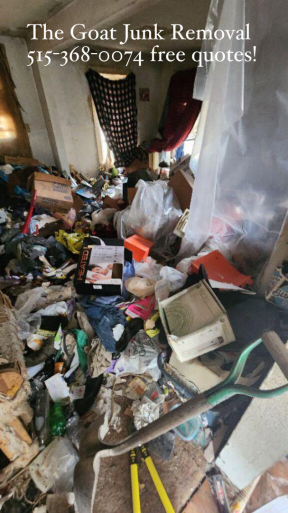 A room completely filled with trash and clutter, depicting a hoarder house cleanout by The Goat Junk Removal in Ankeny, IA