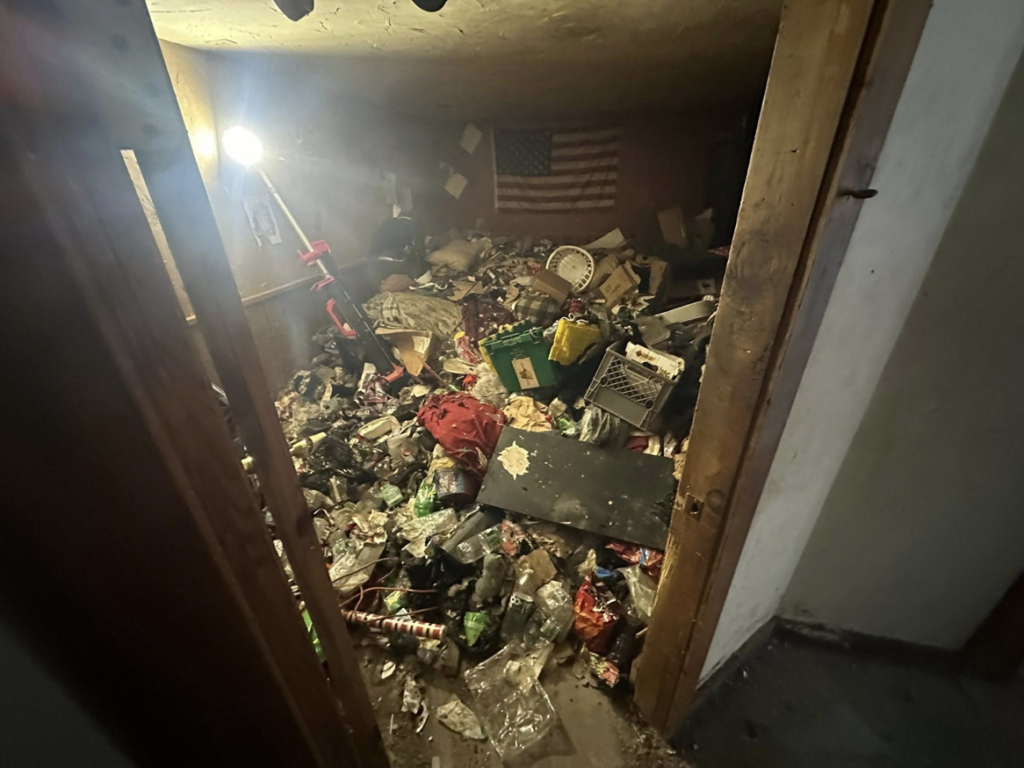 A room completely filled with trash and debris, ready for hoarding cleanup by CleanSite Solutions in Windham, ME.