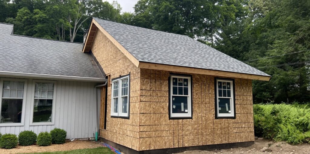 A home addition under construction, showing new sheathing and window installation by Home Made Easy in Norwalk, CT.