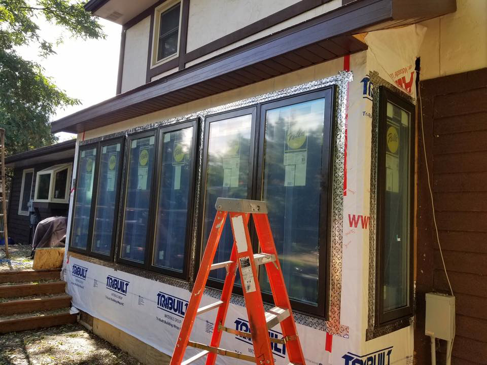 A home addition under construction with new windows and house wrap installed by Gerlach Handyman in Eau Claire, WI.