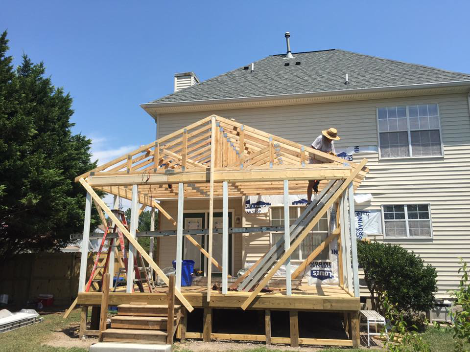 A worker on the roof framing of a home addition under construction by Mason Home Improvement Inc. in Newport News, VA.