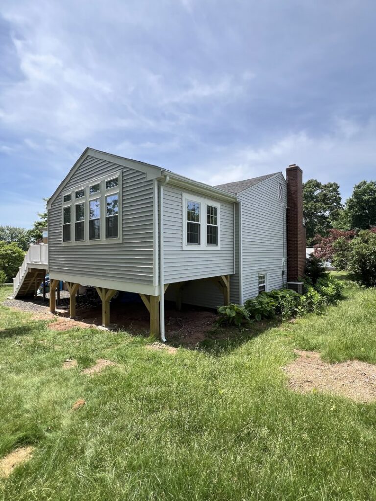 Exterior view of a home addition and new deck construction by Garbatini Contracting in Wallingford, CT.