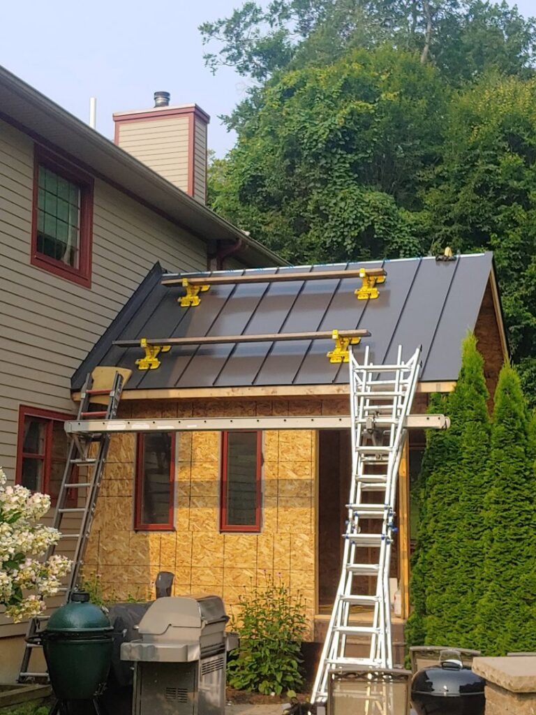 Home addition with metal roofing installation in progress by JB Home Improvement Services in Sanford, FL.