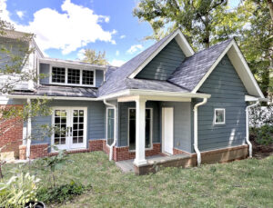 A home addition with new blue siding and brick foundation by Dream Design Build & Remodeling, Inc. in Baltimore, MD