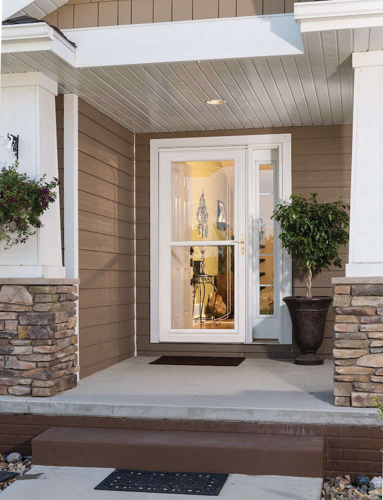 A beautiful home entry featuring a white storm door and main door, installed by Denver Storm Door in Denver, CO.