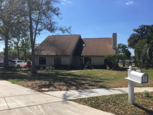 A completed home exterior renovation featuring a new metal roof by Modern Construction Group Inc. in Orlando, FL.