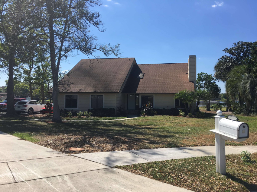 A completed home exterior renovation featuring a new metal roof by Modern Construction Group Inc. in Orlando, FL.